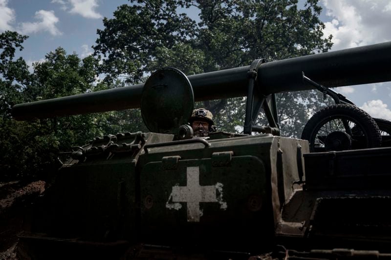 A Ukrainian soldier aka Mechanic of 43rd artillery brigade drives by 2s7 self-propelled howitzer before firing towards Russian positions at the frontline in Donetsk region, Ukraine, Monday, June 10, 2024. (AP Photo/Evgeniy Maloletka)