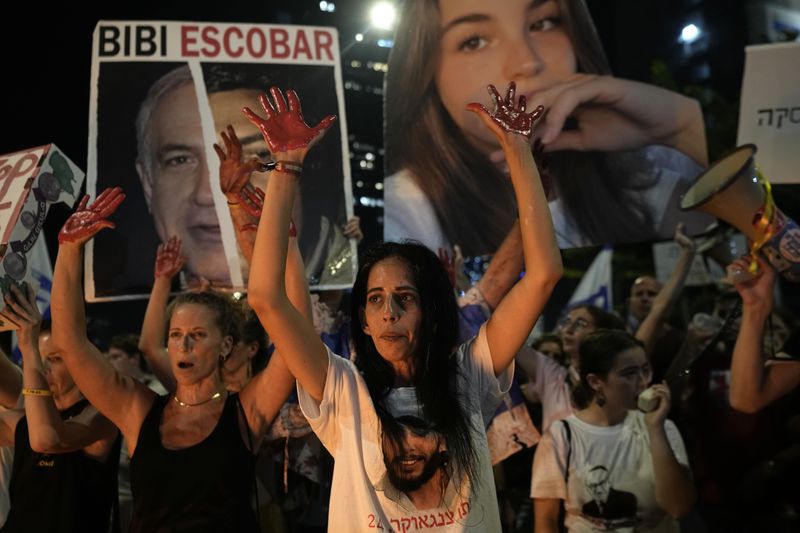 Einav Zangauker, mother of hostage Matan Zangauker, who was kidnapped by Hamas, protests for his immediate release along with other families of hostages held on the Gaza Strip and their supporters and against Israeli Prime Minister Benjamin Netanyahu's government in Tel Aviv, Israel, Saturday, Aug. 17, 2024. (AP Photo/Tsafrir Abayov)