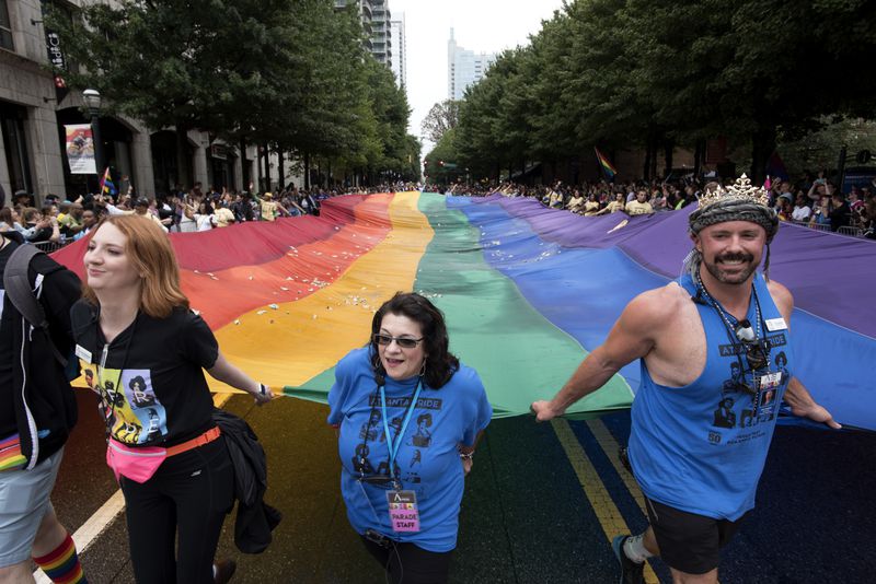 FILE - A massive rainbow flag is carried through the city's Midtown district during the annual Gay Pride Parade in Atlanta, Ga., Oct. 13, 2019. (AP Photo/Robin Rayne, File)