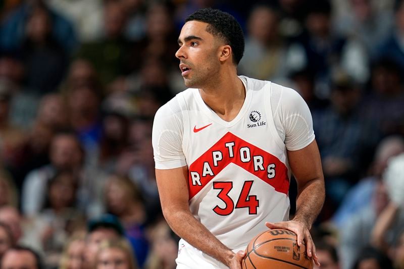 FILE - Toronto Raptors center Jontay Porter (34) looks to pass in the first half of an NBA basketball game Monday, March 11, 2024, in Denver. Court papers indicate that former Toronto Raptors player Jontay Porter will be charged with a federal felony connected to the sports betting scandal that spurred the NBA to ban him for life. (AP Photo/David Zalubowski, File)