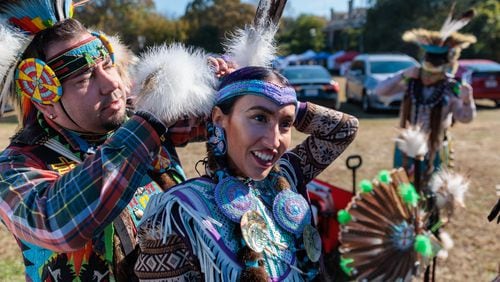 Violet Lauren of Atlanta, a member of the Chickasaw and Cherokee Nations, gets help adjusting her wardrobe before dancing at the inaugural First Voices Festival and powwow in Little Five Points in Atlanta on Saturday, Nov. 19, 2022. Reinhardt University researchers are transcribing property claims filed by Cherokee Indians during the 19th century, illuminating their plight during their forced removal from their homelands in Georgia. (Arvin Temkar / arvin.temkar@ajc.com)