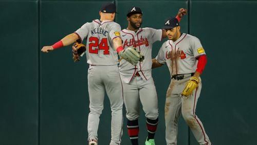 From left, Atlanta Braves left fielder Jarred Kelenic, center fielder Michael Harris and right fielder Ramon Laureano celebrate their team's 5-1 win over the Minnesota Twins after a baseball game Wednesday, Aug. 28, 2024, in Minneapolis. (AP Photo/Bruce Kluckhohn)