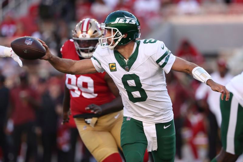 New York Jets quarterback Aaron Rodgers (8) passes the ball as San Francisco 49ers defensive tackle Maliek Collins (99) applies pressure during the first half of an NFL football game in Santa Clara, Calif., Monday, Sept. 9, 2024. (AP Photo/Jed Jacobsohn)