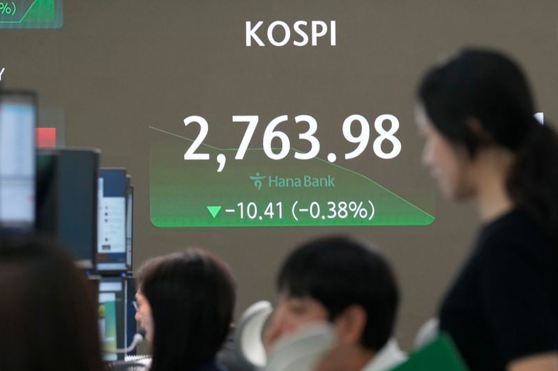 Currency traders watch monitors near the screen showing the Korea Composite Stock Price Index (KOSPI) at the foreign exchange dealing room of the KEB Hana Bank headquarters in Seoul, South Korea, Wednesday, June 26, 2024. (AP Photo/Ahn Young-joon)