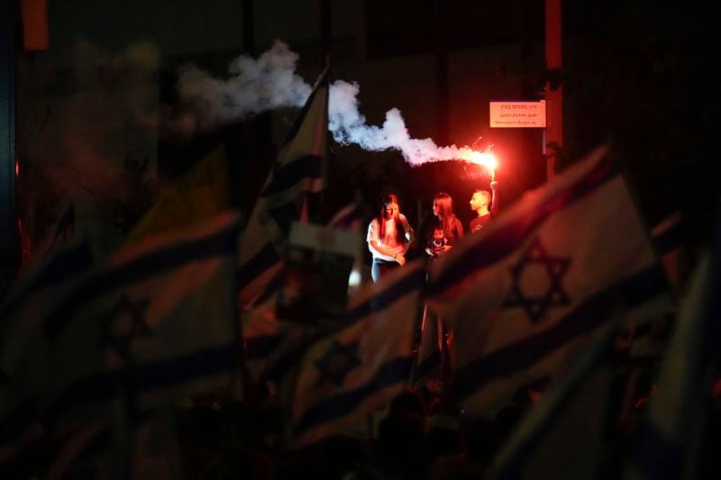 People attend a rally demanding a cease-fire deal and the immediate release of hostages held by Hamas in the Gaza Strip in Tel Aviv, Israel, on Tuesday, Sept. 3, 2024. (AP Photo/Ariel Schalit)