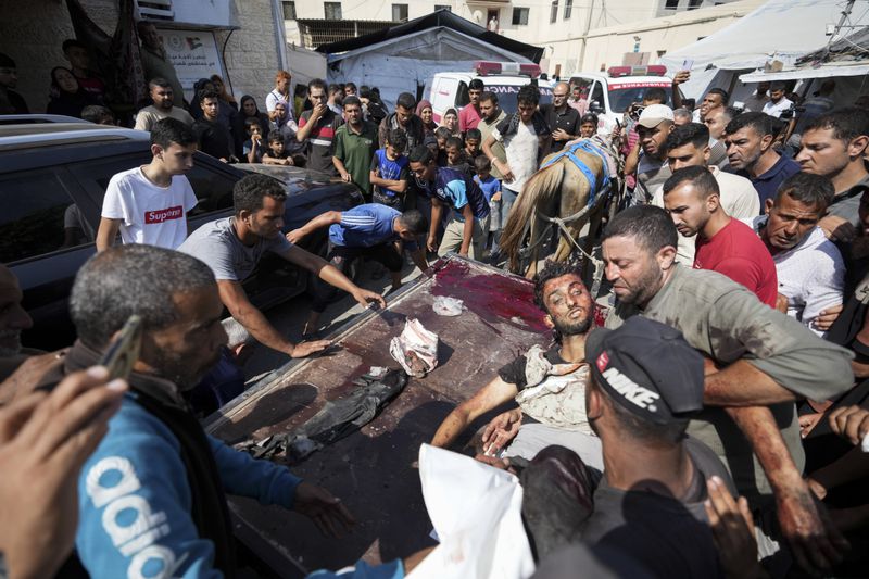 Palestinians killed in the Israeli bombardment of the Gaza Strip are brought to a hospital in Deir al Balah on Tuesday, June 4, 2024. (AP Photo/Abdel Kareem Hana)