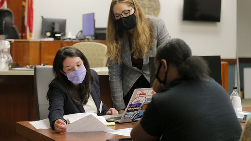 Cobb Legal Aid’s Housing Stability Project attorneys Lauren Kaplan and Jennifer Yankulova work with a tenant before she appears in court at the Cobb County Magistrate Court in Marietta on Tuesday, Aug. 10, 2021. (Christine Tannous / christine.tannous@ajc.com)