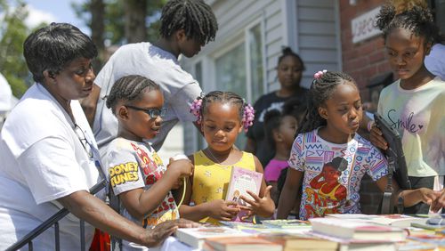 Children take part in Brilliant Detroit's "Street Read" program, where they get to select a book to read to their caregivers or friends outside the nonprofit's Osborn hub in Detroit in 2024. (Brilliant Detroit via AP)