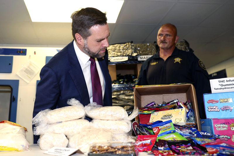 Lowndes County Sheriff's Lt. Herb Bennett (right) briefs Republican vice presidential candidate Sen. JD Vance (R-Ohio) on illegal drugs Thursday, Aug. 22, 2024, in Valdosta, Georgia. (AP Photo/Gary McCullough)