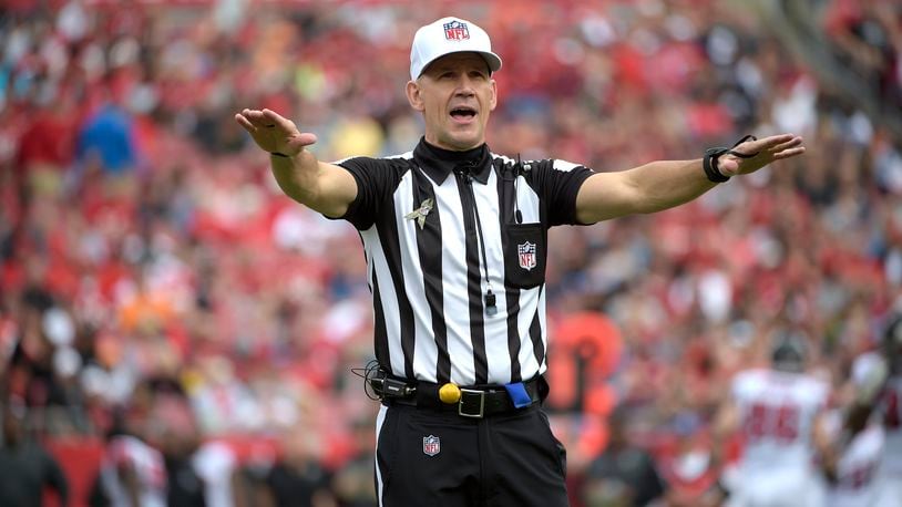 NFL referees discuss a penalty flag thrown during the second half of an NFL  playoff game betwee …