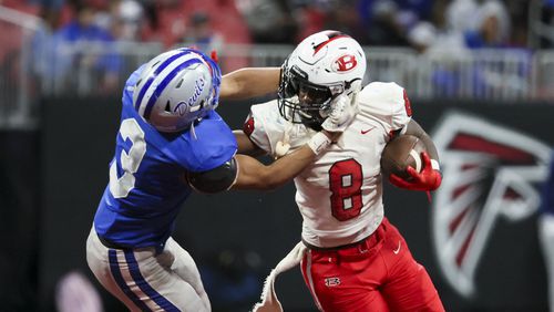 Bowdon quarterback Jordan Beasley (8) gets his facemark grabbed by Manchester linebacker Darius Favors (3) during the second half in the Class A Division II GHSA State Championship game at Mercedes-Benz Stadium, Monday, December. 11, 2023, in Atlanta. Bowdon won 28-27. (Jason Getz / Jason.Getz@ajc.com)