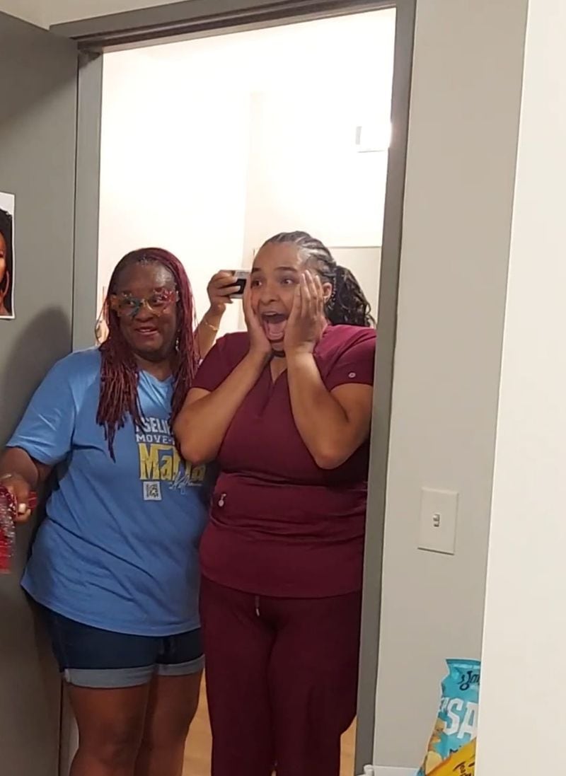 TeeJ Mercer, the director of Move-In Day Mafia, an organization that helps students with their moves to college, surprises a North Carolina Central University student with her newly designed dorm room. Courtesy of TeeJ Mercer