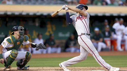 Braves first baseman Matt Olson hits a three-run home run in front of Athletics catcher Sean Murphy during the third inning Tuesday night in Oakland, Calif. (AP Photo/Jed Jacobsohn)