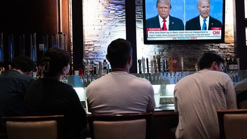 Guests at the Old Town Pour House in Chicago watch the June 27 debate between President Joe Biden and presumptive Republican nominee former President Donald Trump. (Scott Olson/Getty Images/TNS)