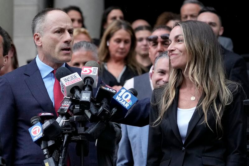 Karen Read, right, smiles as defense attorney David Yannetti, left, speaks to reporters in front of Norfolk Superior Court, Monday, July 1, 2024, in Dedham, Mass. A judge declared a mistrial Monday after jurors deadlocked in the case of Read, who was accused of killing her Boston police officer boyfriend by striking him with her SUV and leaving him in a snowstorm. (AP Photo/Steven Senne)