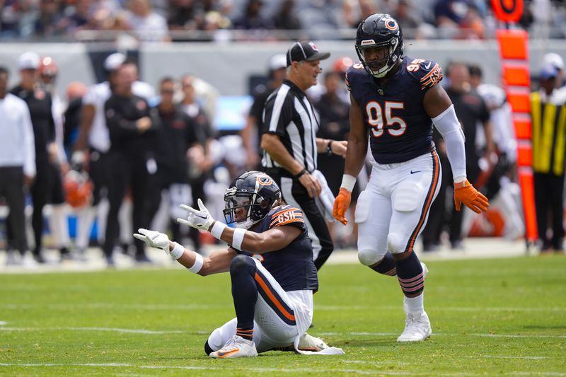 Chicago Bears cornerback Kyler Gordon (6) reacting after sacking Cincinnati Bengals quarterback Logan Woodside (11) during the first half of an NFL preseason football game, Saturday, Aug. 17, 2024, at Soldier Field in Chicago. Also on the field is Chicago Bears defensive end DeMarcus Walker (95). (AP Photo/Charles Rex Arbogast)