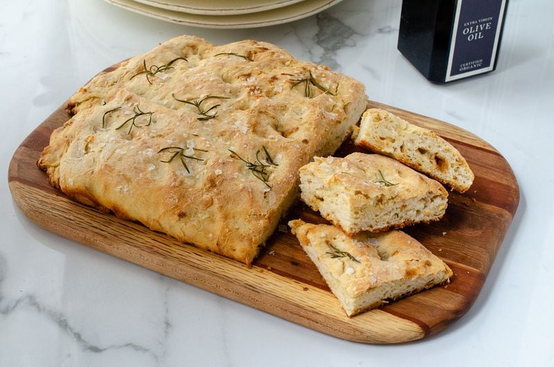 Crisp and toothsome Quick Bread Focaccia, richly colored with olive oil and topped with flaked sea salt and rosemary. (Virginia Willis for The Atlanta Journal-Constitution)