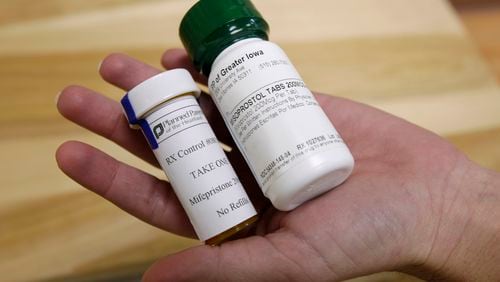 FILE - Bottles of abortion pills mifepristone, left, and misoprostol, right, are displayed at a clinic in Des Moines, Iowa, Sept. 22, 2010. (AP Photo/Charlie Neibergall, File)