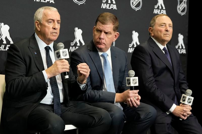 FILE - IIHF president Luc Tardif, left to right, NHLPA Executive Director Marty Walsh and NHL Commissioner Gary Bettman attend a news conference in Toronto, Feb. 2, 2024. (Frank Gunn/The Canadian Press via AP, File)