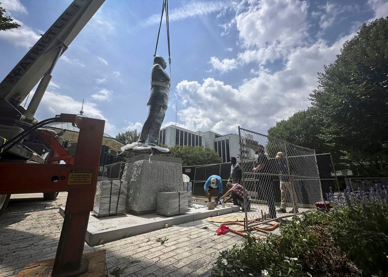 A large bronze statue of U.S. Rep. John Lewis, the late civil rights leader and Atlanta Democrat, is installed in Decatur. Lewis died in 2020.