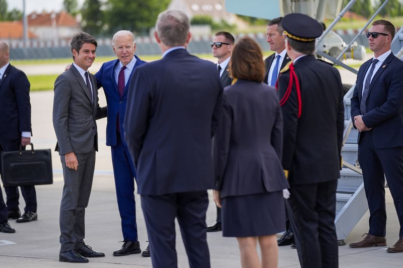 President Joe Biden is welcomed by France's Prime Minister Gabriel Attal, left, after arriving at Orly airport, south of Paris, Wednesday, June 5, 2024. Biden is in France to mark the 80th anniversary of D-Day. (AP Photo/Evan Vucci)