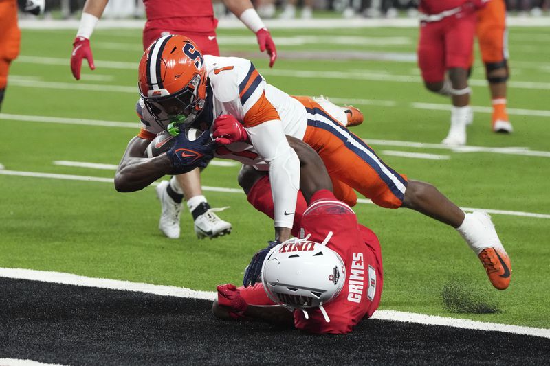 Syracuse running back LeQuint Allen (1) scores a touchdown over UNLV defensive back Tony Grimes, bottom, in the first half during an NCAA college football game, Friday, Oct. 4, 2024, in Las Vegas. (AP Photo/Rick Scuteri)