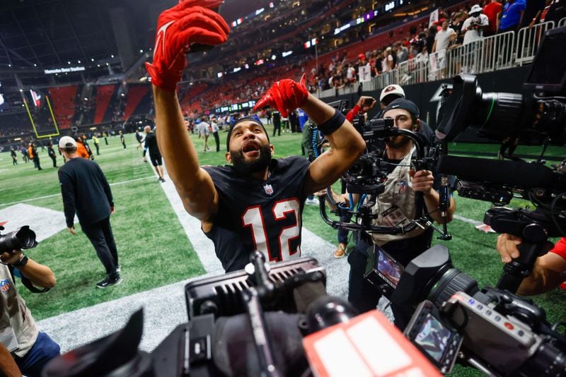 Falcons receiver KhaDarel Hodge celebrates his game-winning touchdown by shooting a cellphone video.