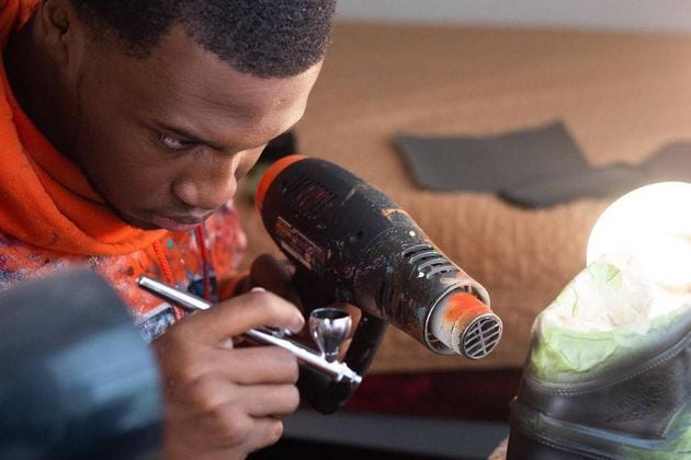 As a young kid, Elijah Rutland asked his parents to buy him a pair of sneakers. When they wouldn't, he began drawing and designing shoes that he now custom paints and sells through his company, Fix My Sole. (Photo provided by Elijah Rutland)