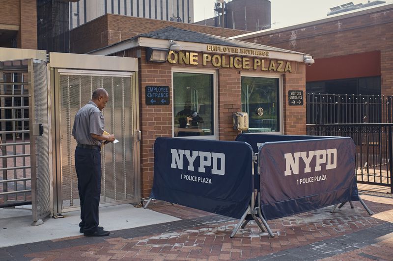 A man styands outside One Police Plaza NYPD Headquarters on Friday, Sept. 13, 2024, in New York. (AP Photo/Andres Kudacki)