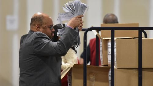 Ralph Jones prepares to recount votes cast in the Atlanta mayoral election runoff at the Fulton County Elections Preparation Center in December. A spokeswoman for Secretary of State Brian Kemp says investigators are planning a forensic review of the contest, which was decided by 821 votes out of nearly 90,000 ballots cast. HYOSUB SHIN / HSHIN@AJC.COM