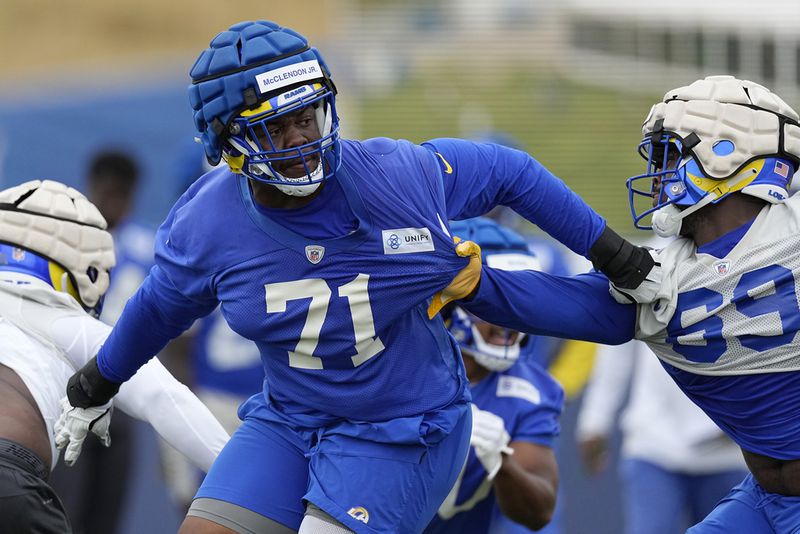 Los Angeles Rams offensive tackle Warren McClendon, left, tries to hold back defensive tackle Taron Vincent during the NFL football team's organized activities Wednesday, May 31, 2023, in Thousand Oaks, Calif. (AP Photo/Mark J. Terrill)