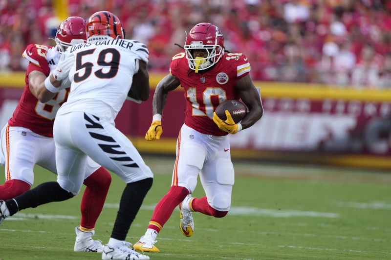 Kansas City Chiefs running back Isiah Pacheco (10) runs with the ball as Cincinnati Bengals linebacker Akeem Davis-Gaither (59) defends during the first half of an NFL football game Sunday, Sept. 15, 2024, in Kansas City, Mo. (AP Photo/Charlie Riedel)