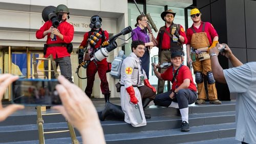 People cosplaying Team Fortress 2 pose for photos at Dragon Con in downtown Atlanta on Friday, August 30, 2024. (Arvin Temkar / AJC)