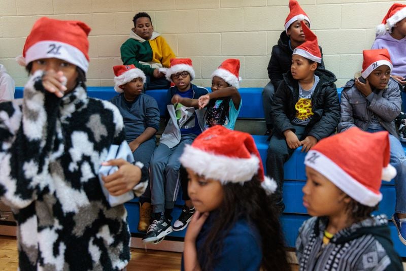 Children at the Wade Walker Park Family YMCA in Stone Mountain wait for gifts from rapper 21 Savage and his Leading By Example Foundation on Wednesday, December 21, 2022. Dec. 21 was pronounced “21 Savage Day” in the state for the rapper’s philanthropic efforts. (Arvin Temkar / arvin.temkar@ajc.com)