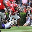 Georgia running back Branson Robinson (22) runs for a touchdown past Tennessee Tech defensive back James Edwards (2) during the second half in an NCAA football game at Sanford Stadium, Saturday, September 9, 2024, in Athens. Georgia won 48-3 over Tennessee Tech. (Hyosub Shin / AJC)