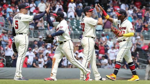 Braves players Freddie Freeman (from left), Guillermo Heredia, Austin Riley and Ronald Acuna celebrate a 7-1 victory over the Pittsburgh Pirates Sunday, May 23, 2021, at Truist Park in Atlanta. (Curtis Compton / Curtis.Compton@ajc.com)