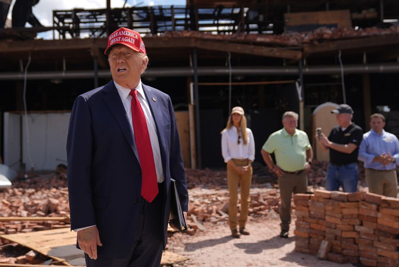 Republican presidential nominee former President Donald Trump speaks as he visits downtown Valdosta, Ga., a town that was impacted by Hurricane Helene, Monday, Sept. 30, 2024. (AP Photo/Evan Vucci)