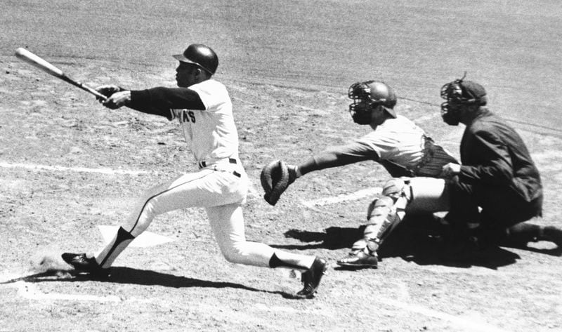 FILE - San Francisco Giants' Willie Mays watches the 3,000th hit of his career, a single to left, in the second inning against the Montreal Expos at Candlestick Park in San Francisco on July 18, 1970. Also watching are Expos catcher John Bateman and umpire Mel Steiner. Mays, the electrifying “Say Hey Kid” whose singular combination of talent, drive and exuberance made him one of baseball’s greatest and most beloved players, has died. He was 93. Mays' family and the San Francisco Giants jointly announced Tuesday night, June 18, 2024, he had “passed away peacefully” Tuesday afternoon surrounded by loved ones. (AP Photo/Robert H. Houston, File)