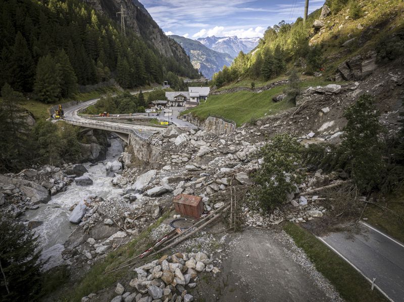 A road is blocked in Eisten, Switzerland, Friday, Sept. 5, 2024, after a landslide following severe weather. (Andrea Soltermann/Keystone via AP)