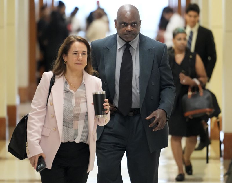 Defense attorney Nicole DeBorde Hochglaube, left, and her client, former Houston police officer Gerald Goines, arrive to the 482nd District Court to await a verdict in his murder trial at the Harris County Criminal courthouse Wednesday, Sept. 25, 2024, in Houston. Goines faces two felony murder charges in the January 2019 deaths of Dennis Tuttle and Rhogena Nicholas. (Melissa Phillip/Houston Chronicle via AP)