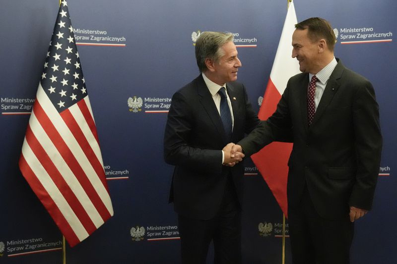 U.S. Secretary of State Antony Blinken, left, welcomes by Polish Foreign Minister Radosław Sikorski, right, for talks in Warsaw, Poland, Thursday, Sept. 12, 2024. (AP Photo/Mark Schiefelbein, Pool)