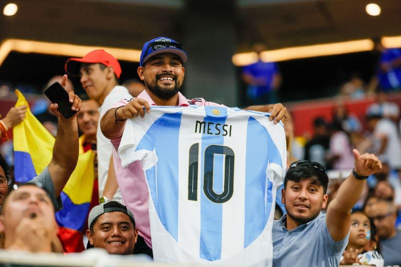 Argentina fans show a Lionel Messi jersey moments before the inaugural Copa America game between Argentina and Canada at Mercedes-Benz Stadium. 
(Miguel Martinez / AJC)