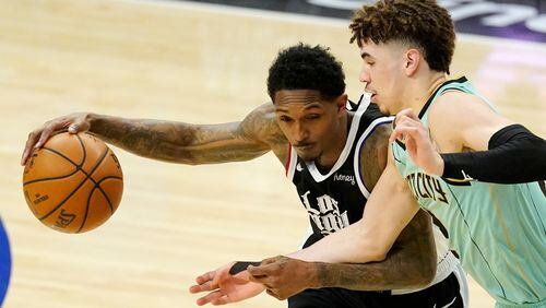 Los Angeles Clippers guard Lou Williams, left, tries to drive past Charlotte Hornets guard LaMelo Ball during the second half of an NBA basketball game Saturday, March 20, 2021, in Los Angeles. The Clippers won 125-98. (AP Photo/Mark J. Terrill)