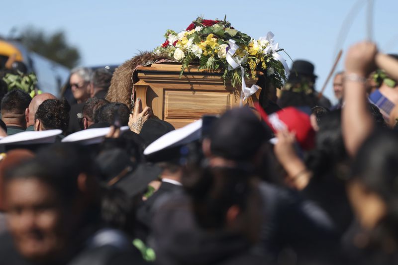 The coffin with the body of New Zealand's Maori King, Kiingi Tuheitia Pootatau Te Wherowhero VII, is carried up Taupiri Mountain for burial in Ngaruawahia, New Zealand, Thursday, Sept. 5, 2024. (AP Photo/Alan Gibson)