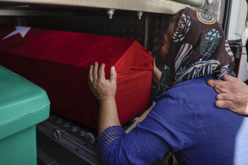 A relative of Aysenur Ezgi Eygi, a 26 year-old Turkish-American activist killed by the Israeli military, mourns over her coffin during her funeral in Didim, Turkey, Saturday, Sept. 14, 2024,(AP Photo/Khalil Hamra)