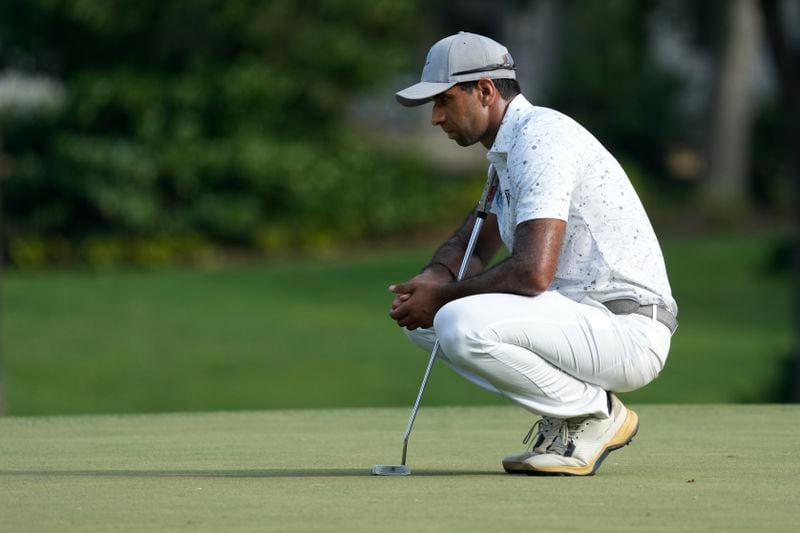 Aaron Rai, of England, lines up a putt on the ninth hole during the final round of the Wyndham Championship golf tournament in Greensboro, N.C., Sunday, Aug. 11, 2024. (AP Photo/Chuck Burton)