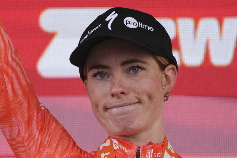 Stage winner Demi Vollering of The Netherlands reacts on the podium after the eighth stage of the Tour de France Women cycling race with start in Le Grand-Bornand and finish in Alpe d'Huez, France, Sunday, Aug. 18, 2024. (AP Photo/Peter Dejong)