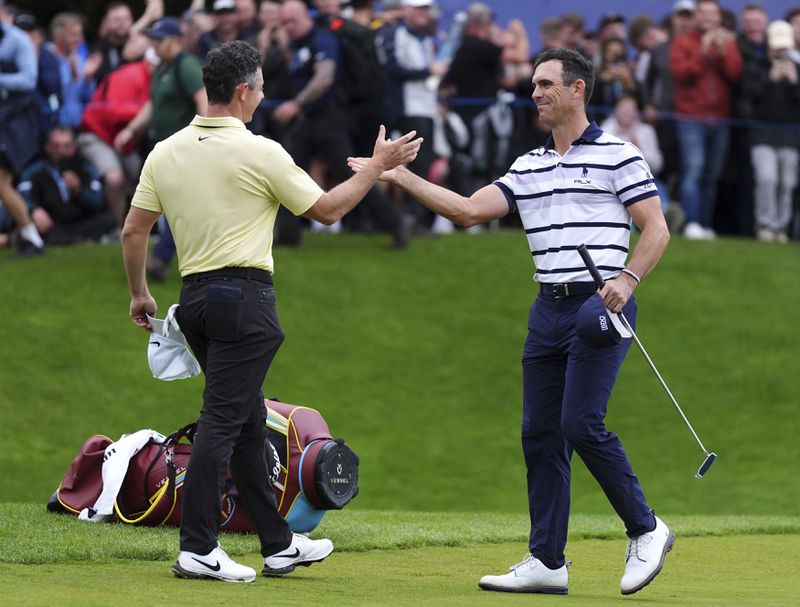 Northern Ireland's Rory McIlroy congratulates first place Billy Horschel of the U.S., following day four of the PGA Championship at Wentworth Golf Club in Virginia Water, England, Sunday Sept. 22, 2024. (Zac Goodwin/PA via AP)