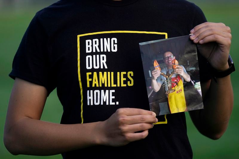 FILE - Harrison Li holds a photo of his father, Kai Li, as he poses for a photo, Jan. 23, 2024, in Palo Alto, Calif. (AP Photo/Jeff Chiu, File)