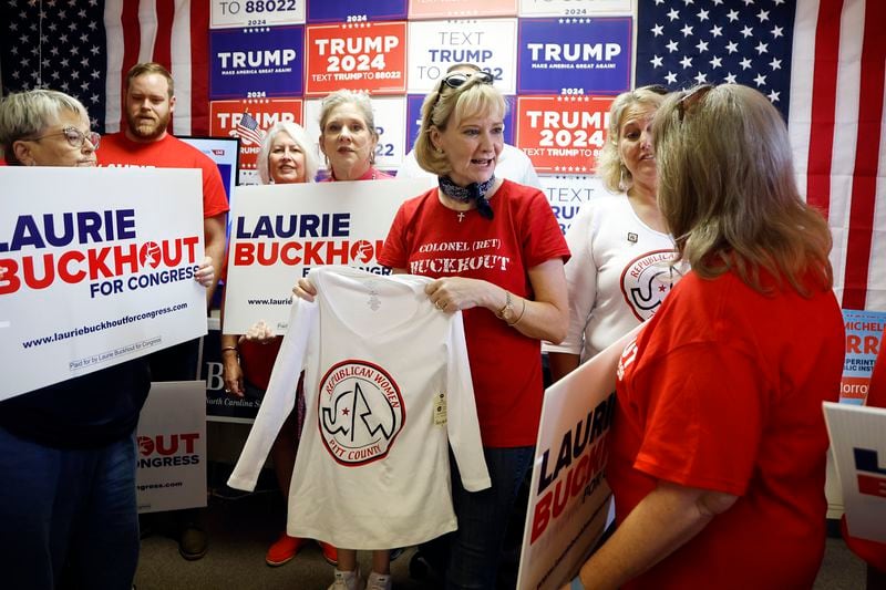 Congressional candidate Laurie Buckhout, R-N.C., second from right, speaks to a supporter prior to a staff photo at the Nash County Republican headquarters in Rocky Mount, N.C., Friday, Sept. 20, 2024. (AP Photo/Karl B DeBlaker)